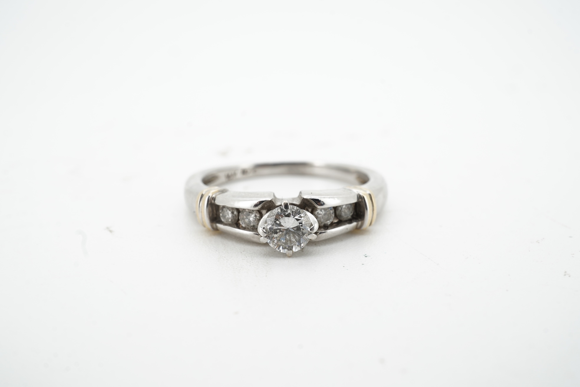 A diamond half-hoop ring, mid 19th century, pavé-set to the front with three rows of cushion-shaped diamonds totalling approximately 0.80 carats, to foliate carved shoulders, mounted in gold, size O, gross weight approxi